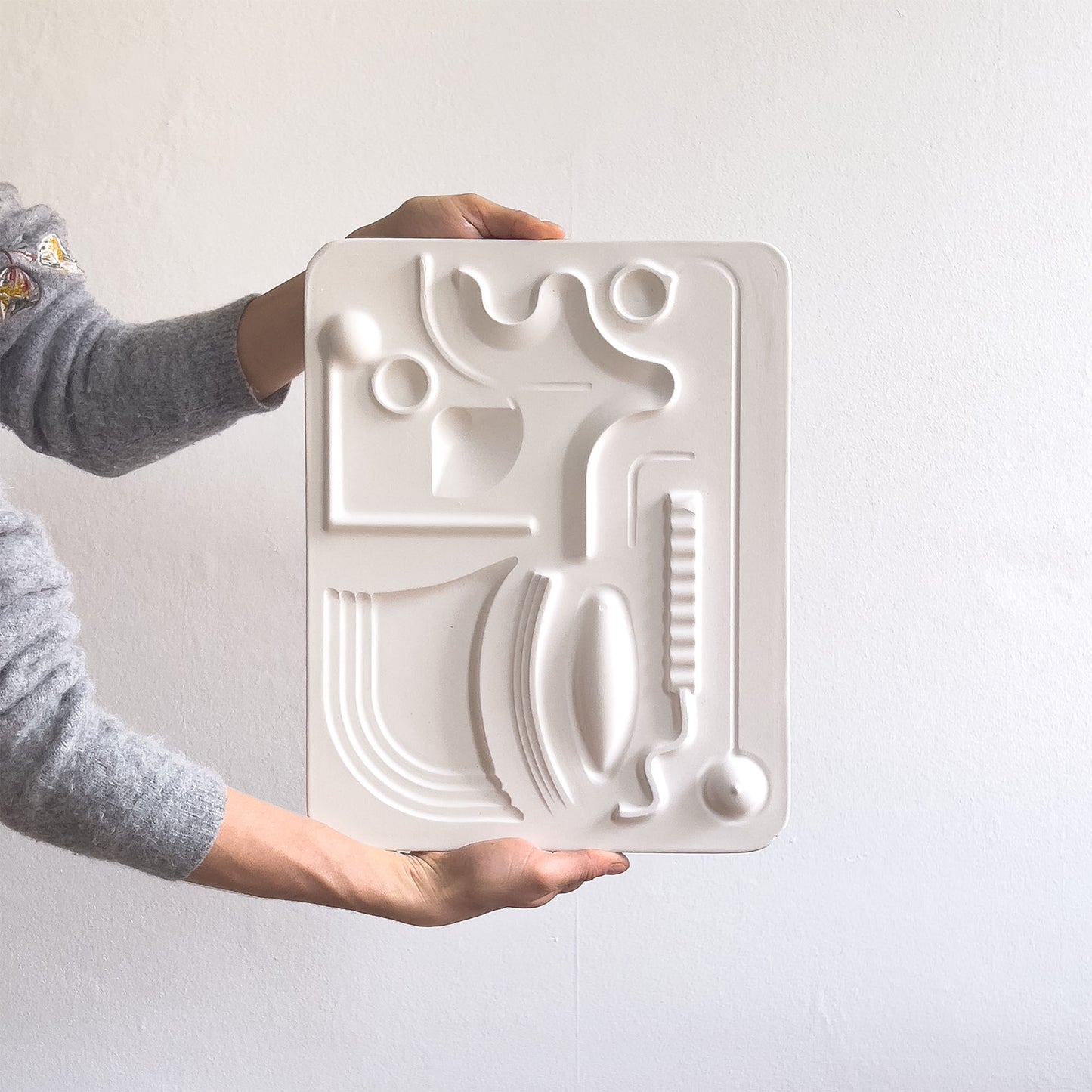 Flowing Centre, a relief artwork made from plaster photographed against a white background