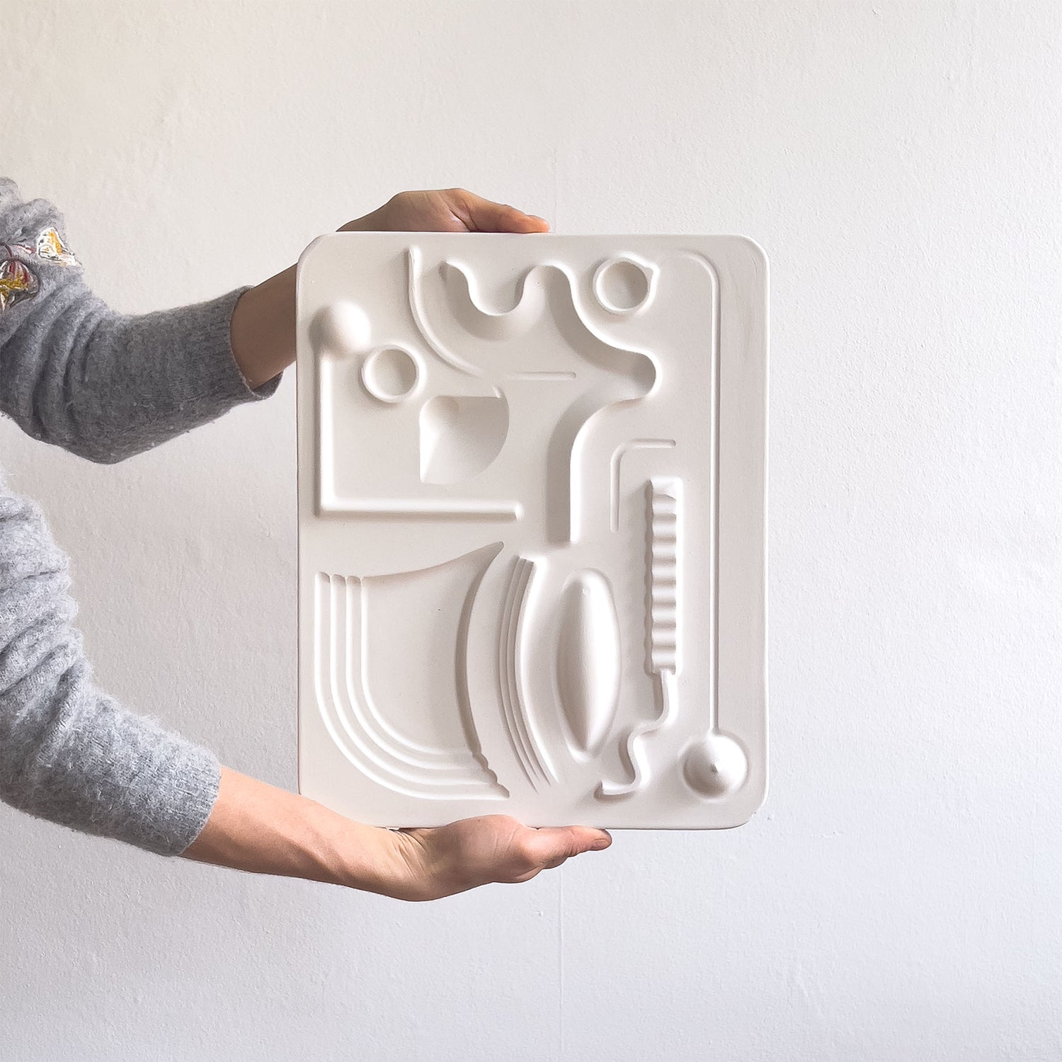 Flowing Centre, a relief artwork made from plaster photographed against a white background