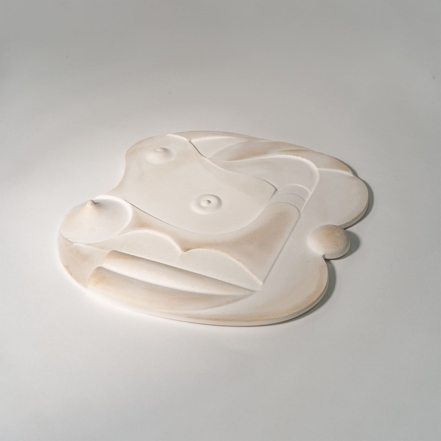 Mask 3, a relief artwork made from plaster, photographed against a white background