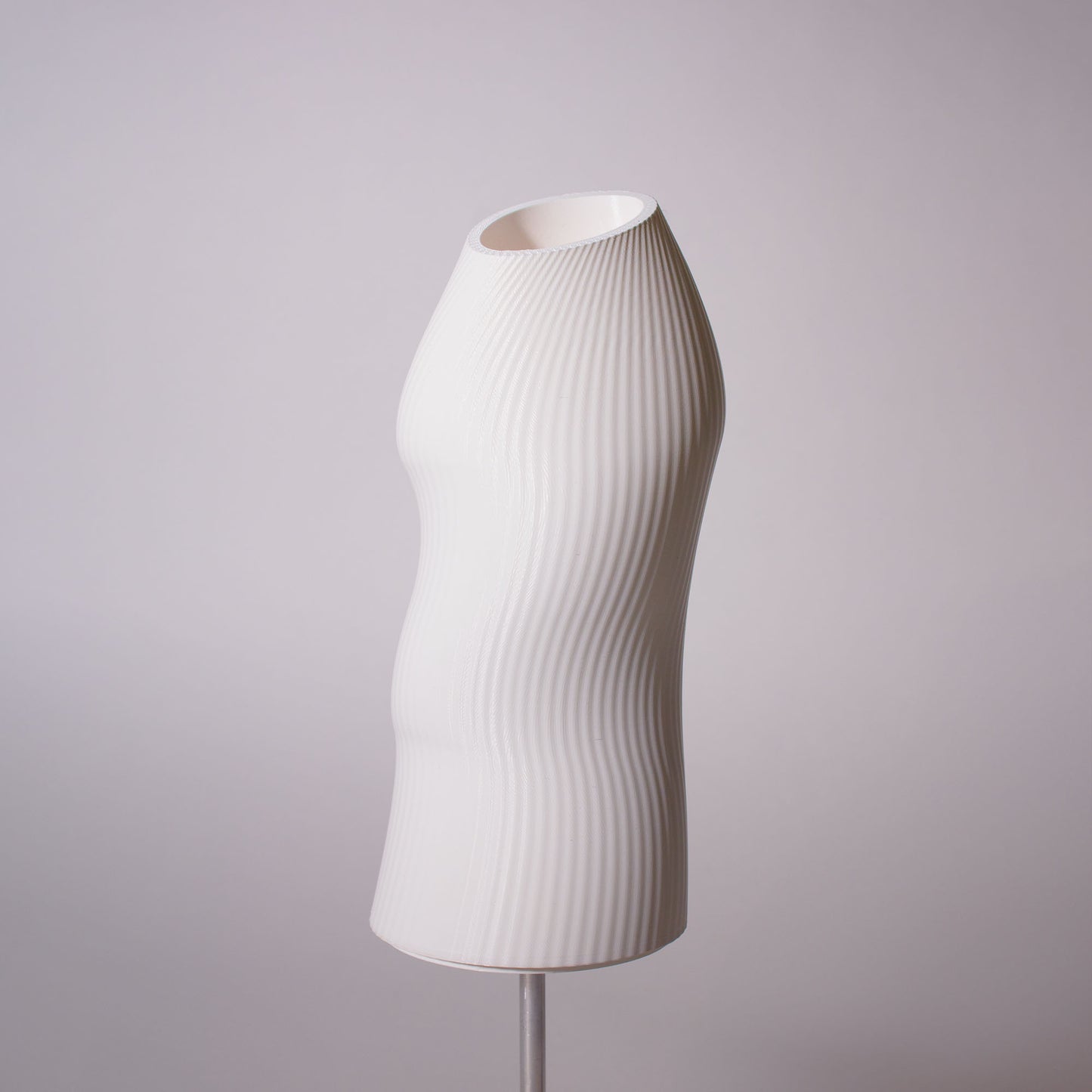 The lampshae of the Ora table lamp showing a pleated texture photographed against a white background