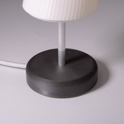 Black base of the Ora table lamp photographed against a white background