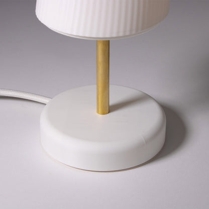 White base of the Ora table lamp photographed against a white background