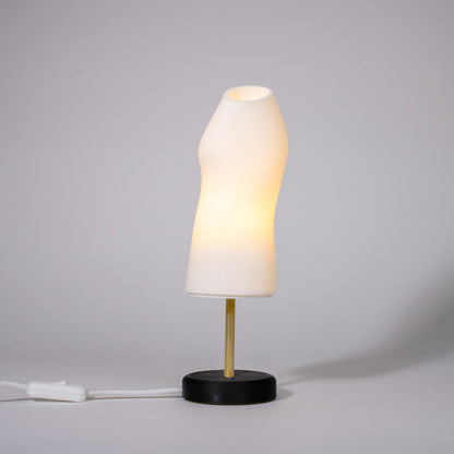 Ora white sculptural table lamp with black base and a brass rod photographed against a white background