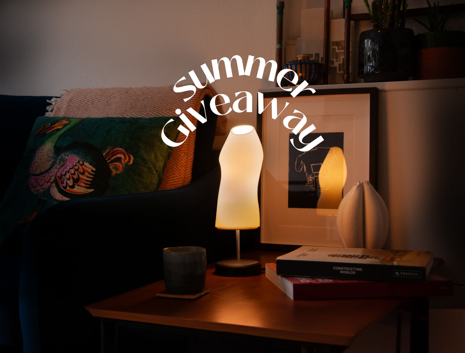 summer 2024 giveaway poster showing an Ora lamp lighting up a dark living room